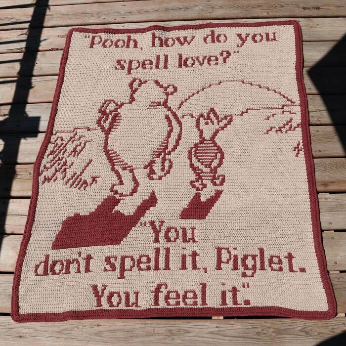 Crocheted blanket featuring Pooh and Piglet with a heartfelt quote, showcasing advanced crocheting skills and detailed stitch work.