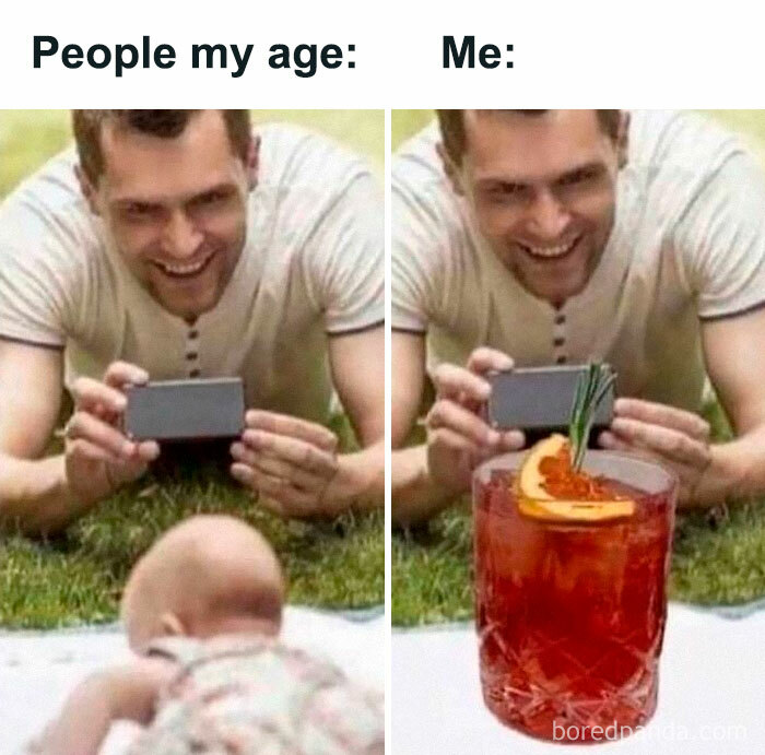 Adult man lying on grass taking photos, comparing typical people to introvert-worthy memes with a cocktail instead of a baby.