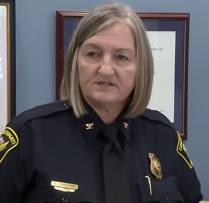 Female Cincinnati police chief in uniform speaking during a press conference related to a single mom incident. Female Cincinnati police chief in uniform speaking during a press conference related to a single mom incident.