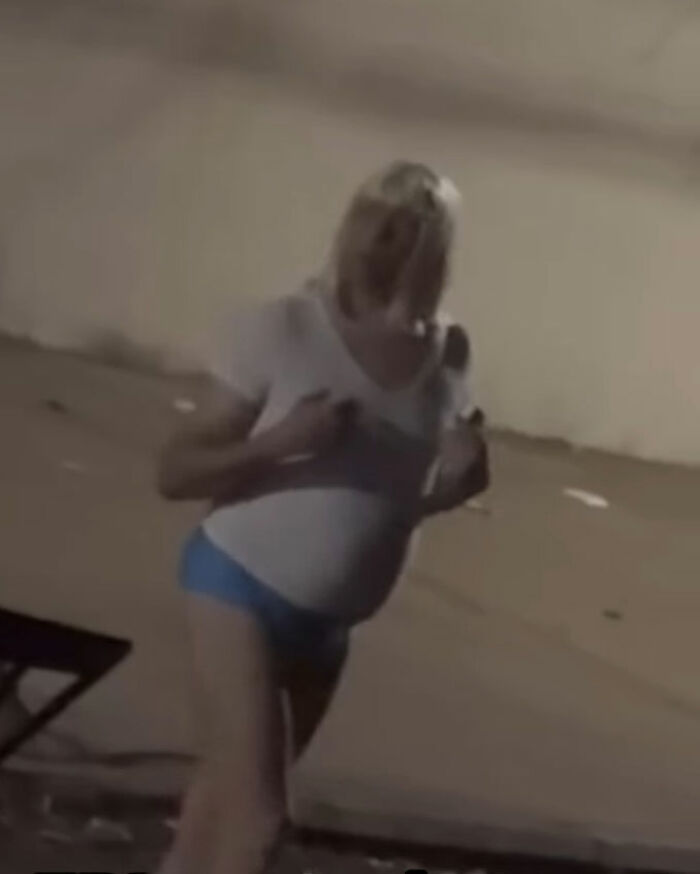 Pastor wearing a wig and thong, claiming to be undercover, stirring reactions and memes in an outdoor nighttime setting. Pastor wearing a wig and thong, claiming to be undercover, stirring reactions and memes in an outdoor nighttime setting.