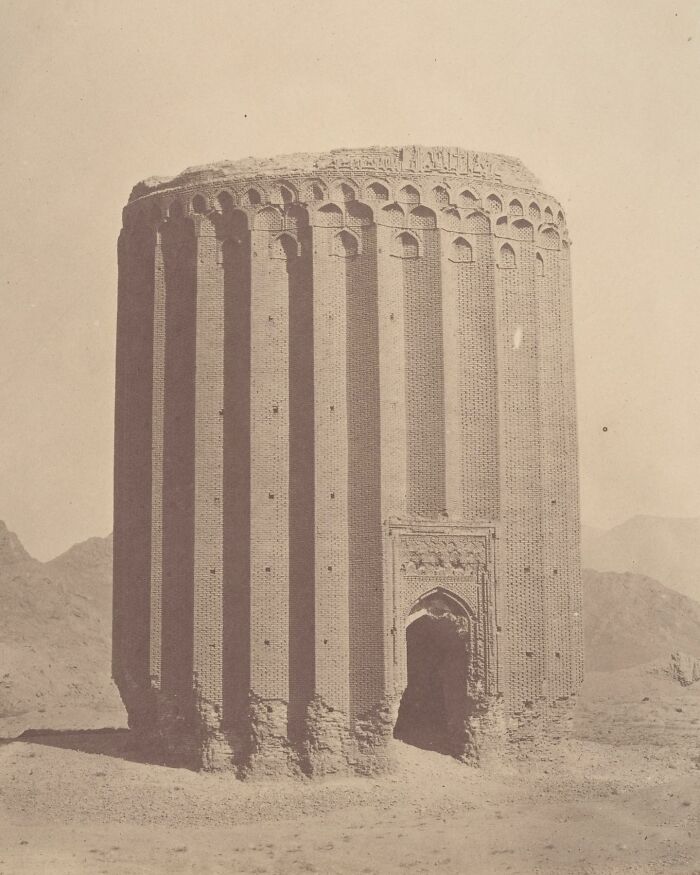 Ancient brick tower ruins standing alone in a barren landscape, showcasing unfamiliar parts of history architecture.