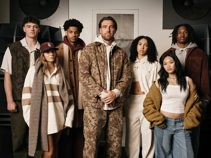 Group of diverse young adults posing together in stylish casual and patterned clothing for a marketing stunt campaign.