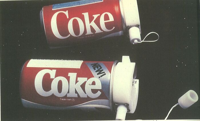 Two vintage Coca-Cola cans with broken spray tops representing PR campaign fails and poor decisions.