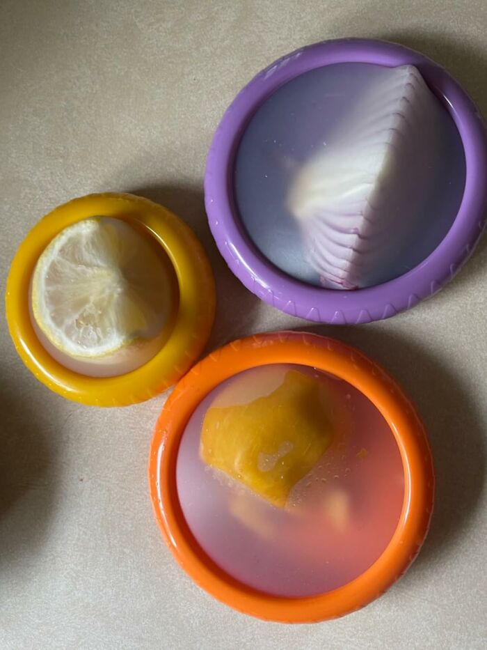 Silicone food covers sealing cut lemon and mango pieces, essential dorm kitchen survival tool for freshness.