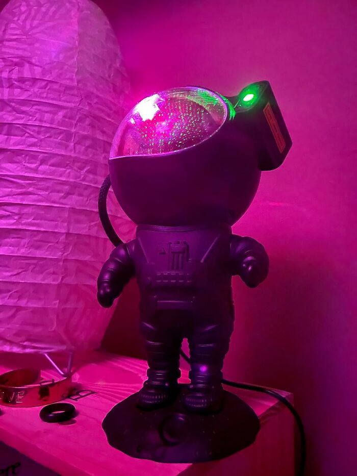 Astronaut lamp glowing with colorful lights, a creative gift idea for friends barely holding it together.