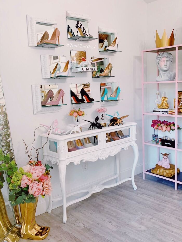 Elegant tiny apartment furniture piece with mirrored shoe display and decorative items in a bright, modern living space.