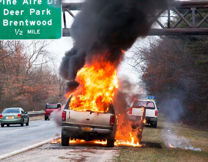 Pickup truck engulfed in flames on roadside, illustrating one of the most insane reasons employees skipped their work day.