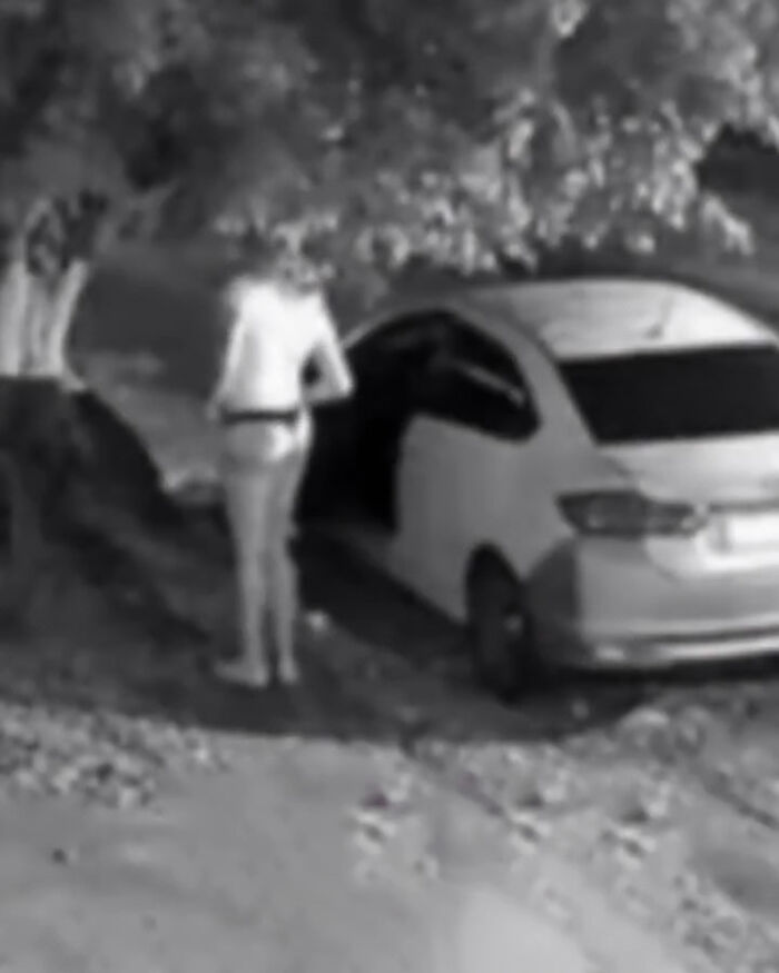 Person wearing thong and wig standing near a car at night, related to pastor caught undercover and viral memes. Person wearing thong and wig standing near a car at night, related to pastor caught undercover and viral memes.