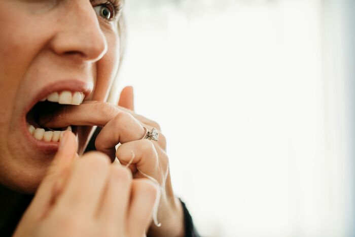 Close-up of a woman flossing teeth, demonstrating a tiny habit that could help prevent heart attack and dementia.