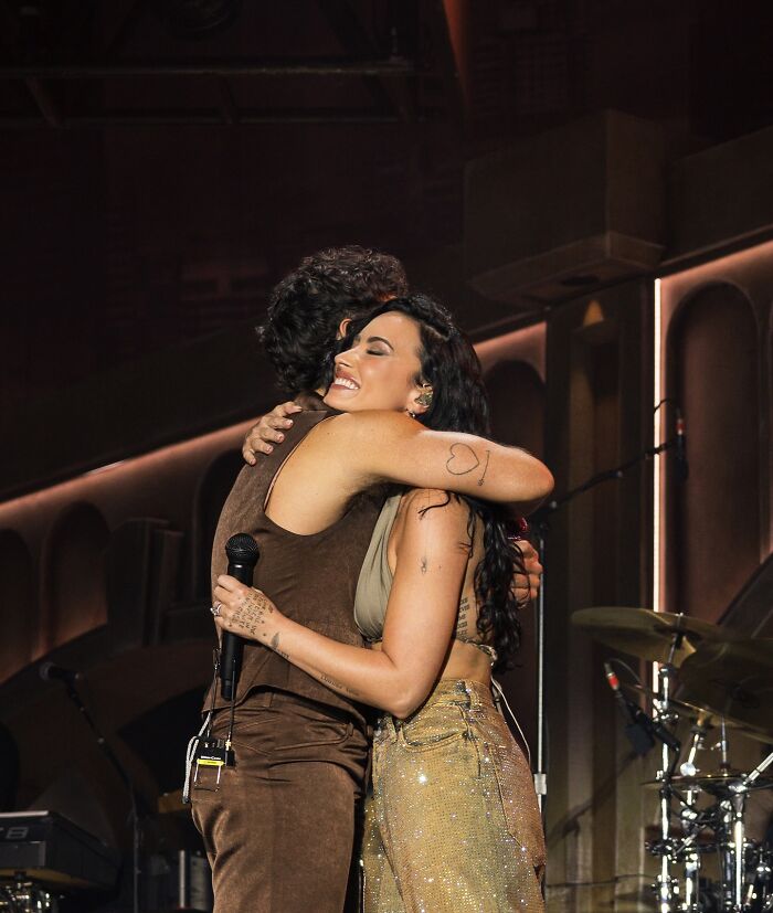 Nick Jonas and Demi Lovato hugging on stage during a live performance, revealing personal relationship insights. Nick Jonas and Demi Lovato hugging on stage during a live performance, revealing personal relationship insights.