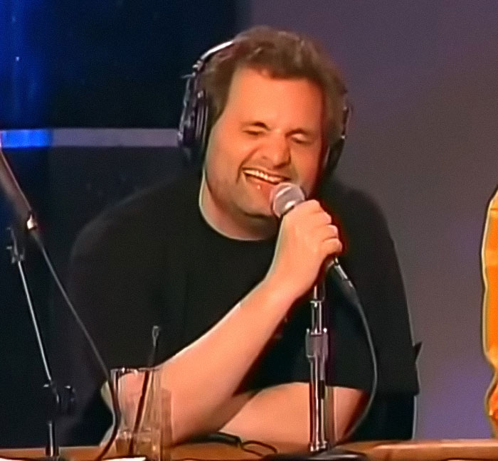 Man wearing headphones laughing while speaking into microphone during a podcast about Miss Buttaface and Zendaya comparison outrage. Man wearing headphones laughing while speaking into microphone during a podcast about Miss Buttaface and Zendaya comparison outrage.