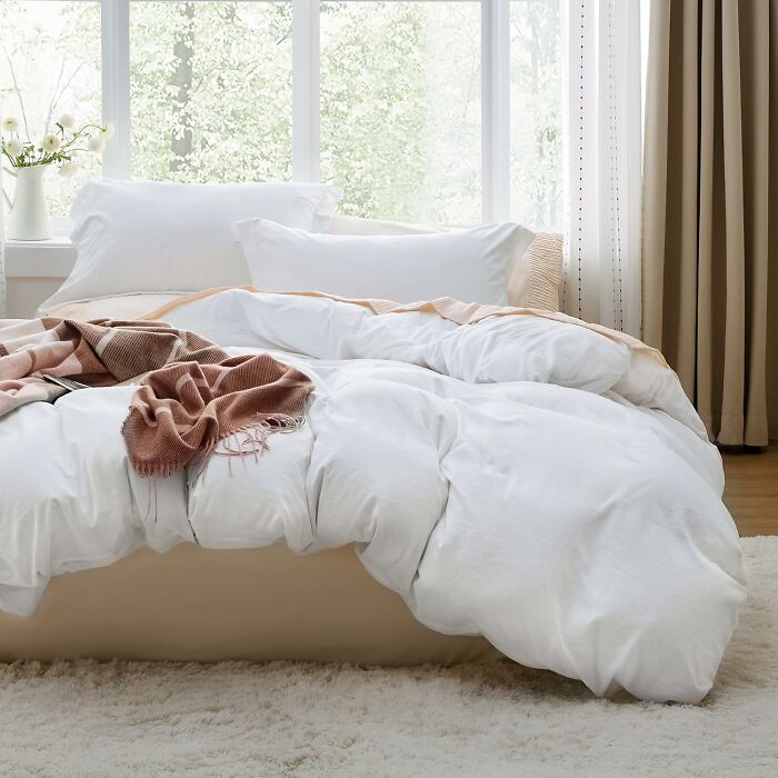 Cozy bedroom with soft white bedding and a brown throw blanket, featuring Amazon's best seller list top products.