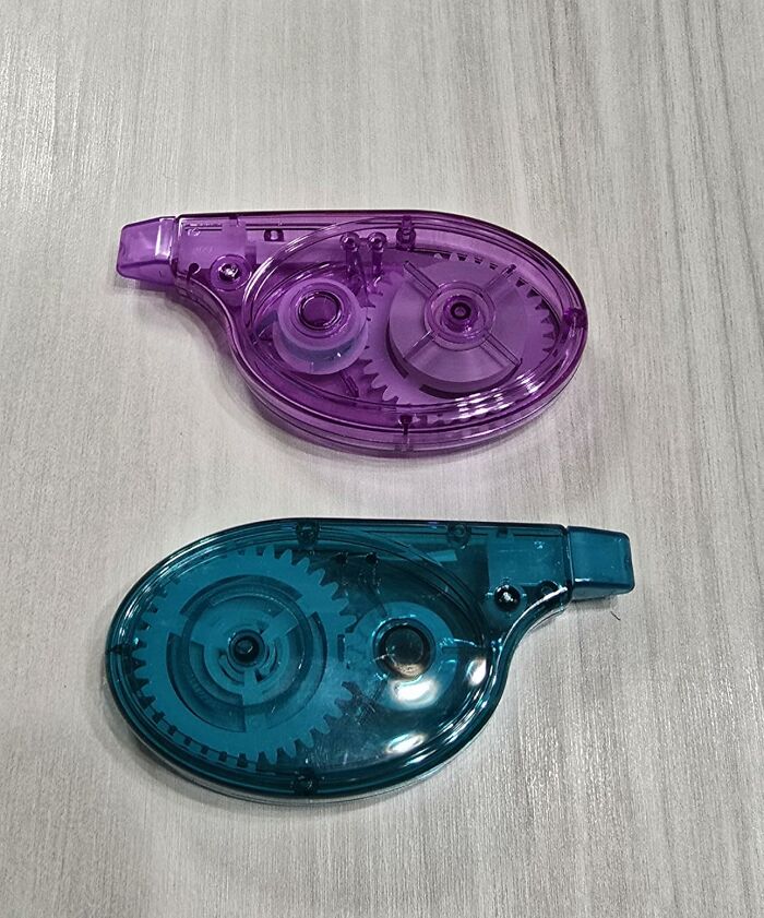 Purple and blue correction tape dispensers on a light wooden surface, essential back to school finds for students.