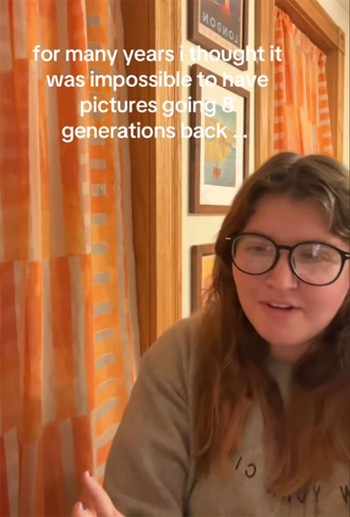 Young woman with glasses in a cozy room sharing insights about family historian research and generations of ancestry photos.