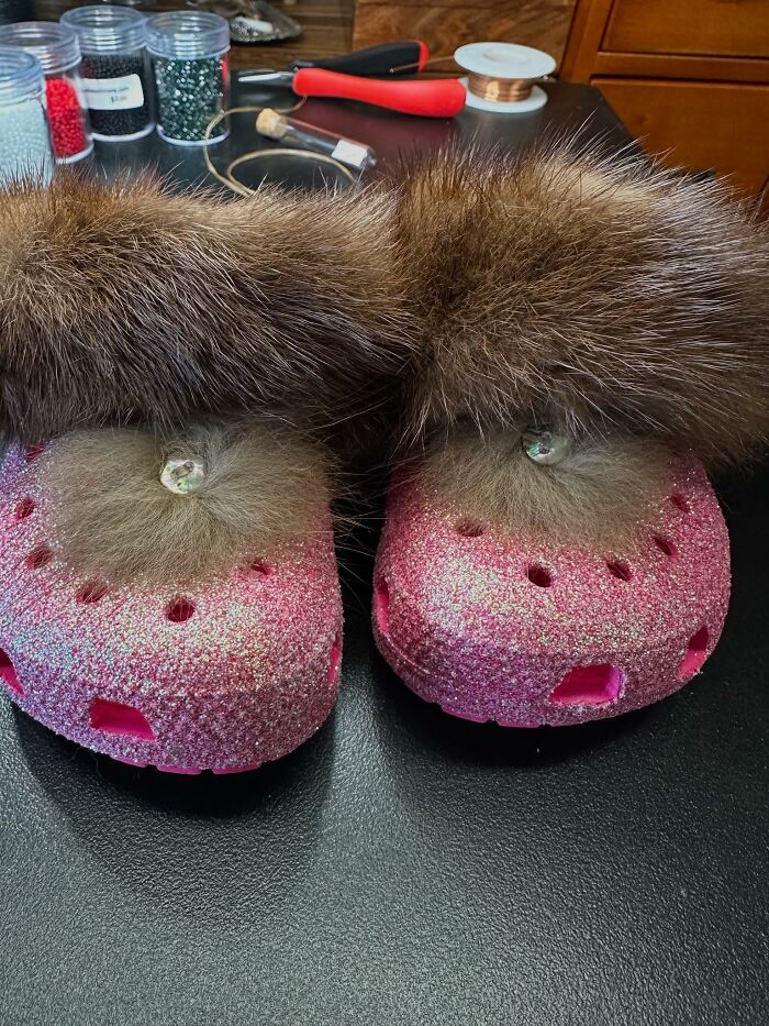 Pink glittery Crocs with fluffy fur and a rhinestone decoration, a craft shaming example of a DIY project gone wrong.