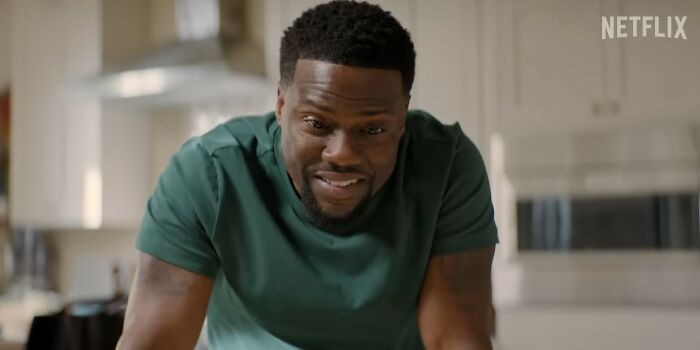Kevin Hart smiling in a kitchen setting, representing popular Netflix movies that turned out to be letdowns.