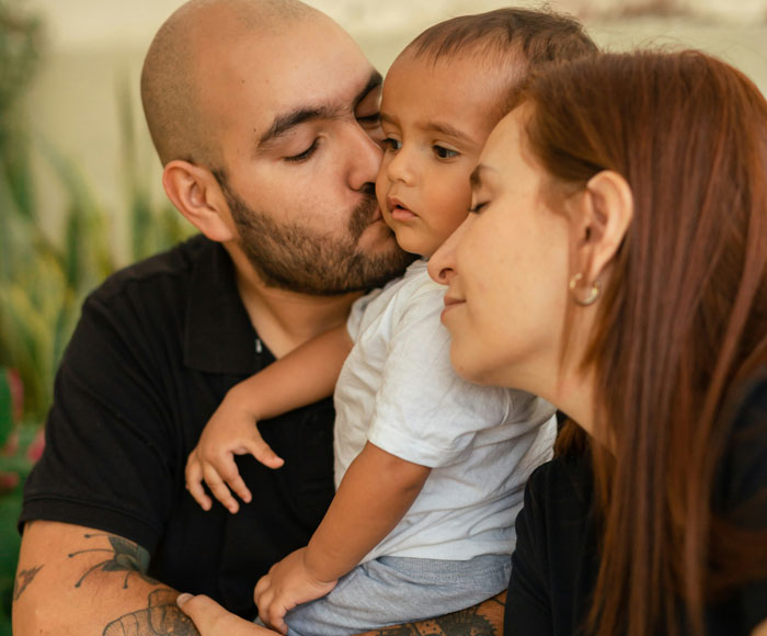 Man and woman showing affection to toddler, highlighting sibling relationship and refusal to babysit after years of distance. Man and woman showing affection to toddler, highlighting sibling relationship and refusal to babysit after years of distance.