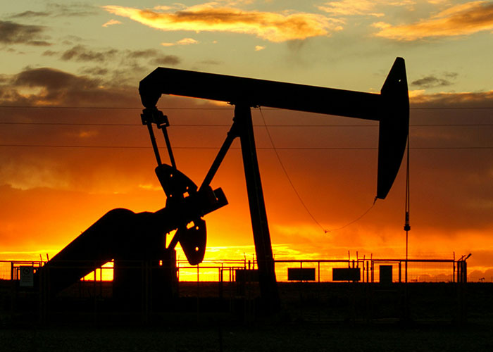 Silhouette of oil rig pump at sunset representing jobs that only a person without a soul would do in harsh conditions