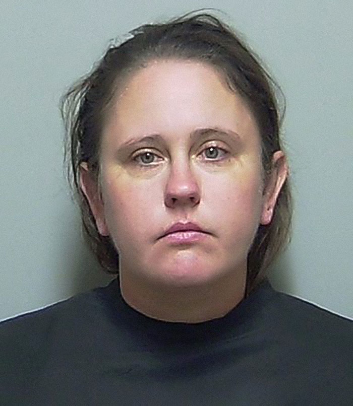 Mugshot of Florida mother involved in abandoning her child and seven dogs for two weeks to go on vacation.