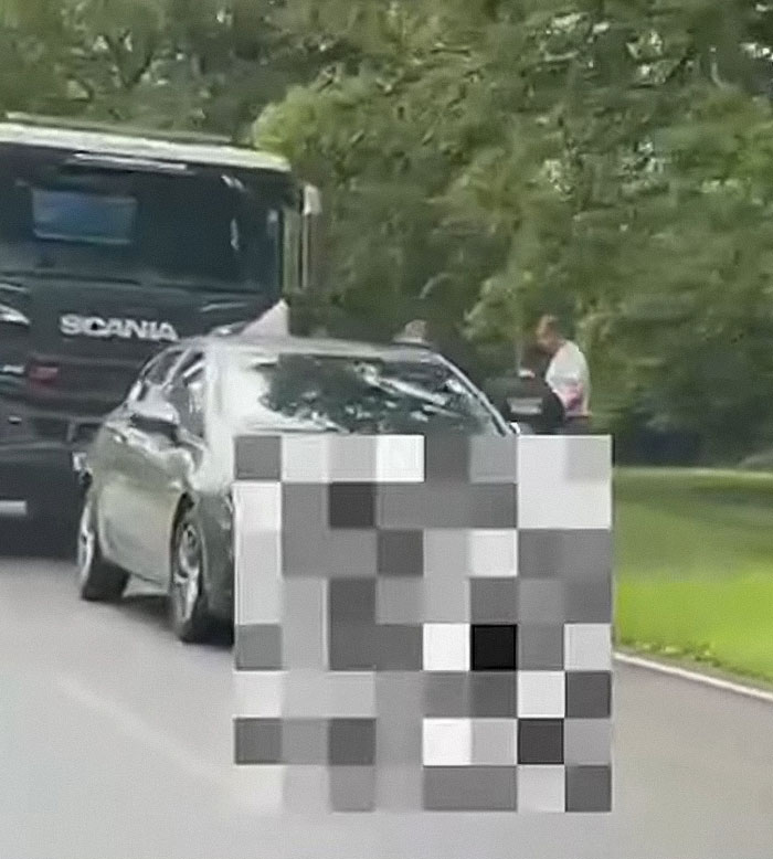 Police officers wearing running clothes standing by a car during a sting operation targeting men who catcall.