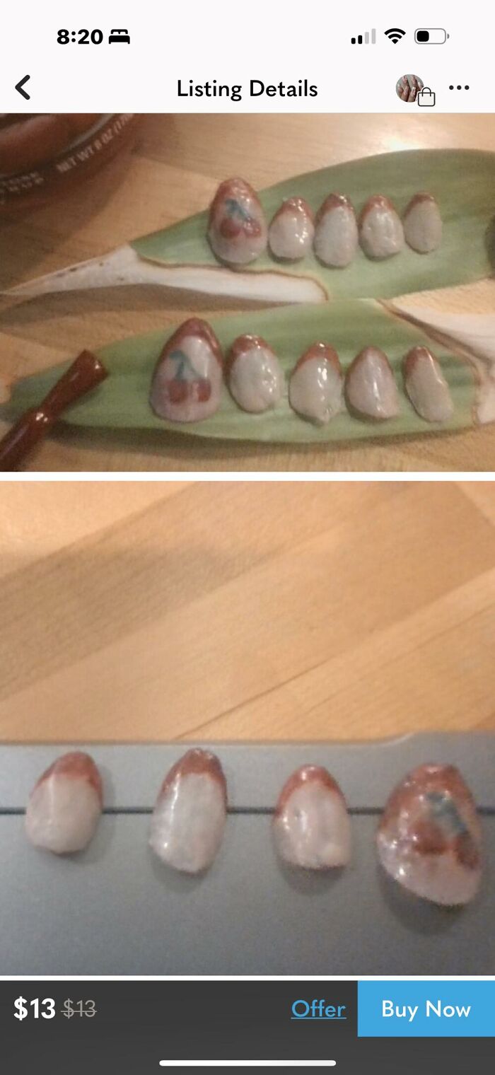 Craft shaming example showing poorly made fake nails with uneven shapes and painted designs on a table surface.