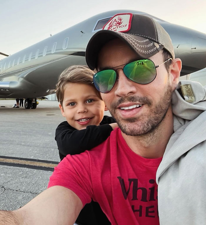 Enrique Iglesias smiling with a child near a private jet, linked to Anna Kournikova pregnancy announcement at 44. Enrique Iglesias smiling with a child near a private jet, linked to Anna Kournikova pregnancy announcement at 44.