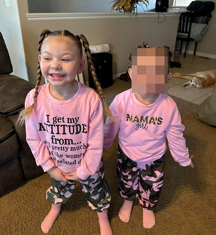 Two young girls in matching pink tops and camo pants, illustrating family awarded nearly a billion dollars case.