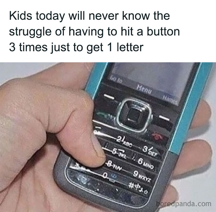 Hand holding old mobile phone with keypad, highlighting 90s kids nostalgia of texting by pressing keys multiple times.