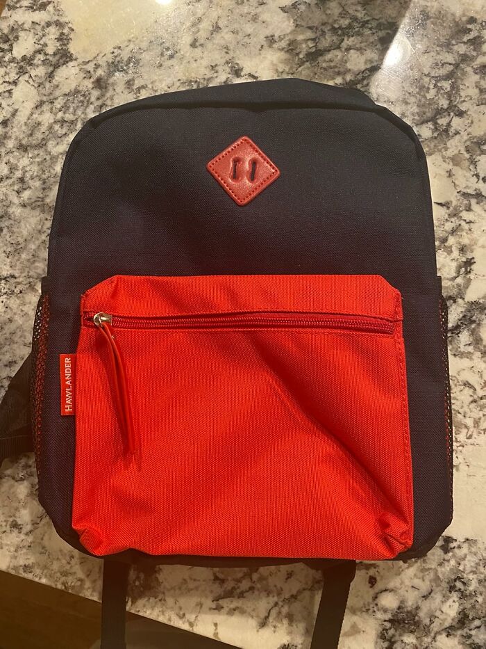 Black and red backpack on marble countertop, a top back to school find for organizing supplies before the school year starts