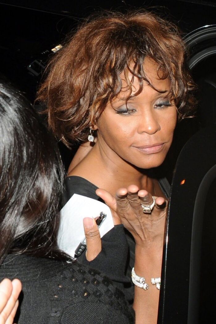 Woman with short curly hair and jewelry appearing contemplative amid unsettling images from Morbid Knowledge online group.