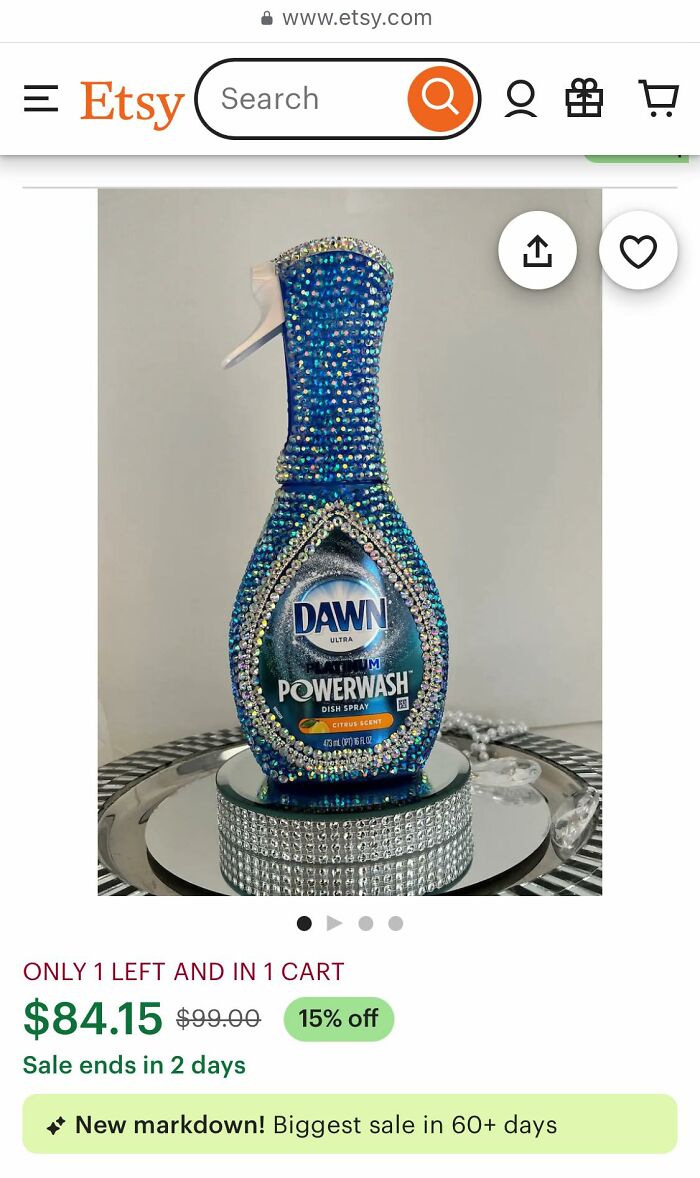Dawn dish soap bottle covered in blue and silver rhinestones as a craft shaming DIY project on a mirrored base.