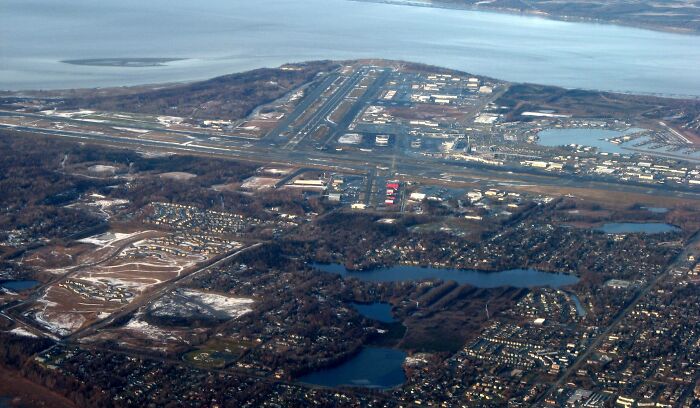 Aerial view of a coastal city near water, illustrating the habitat of the fish with the scientific name Boops Boops.