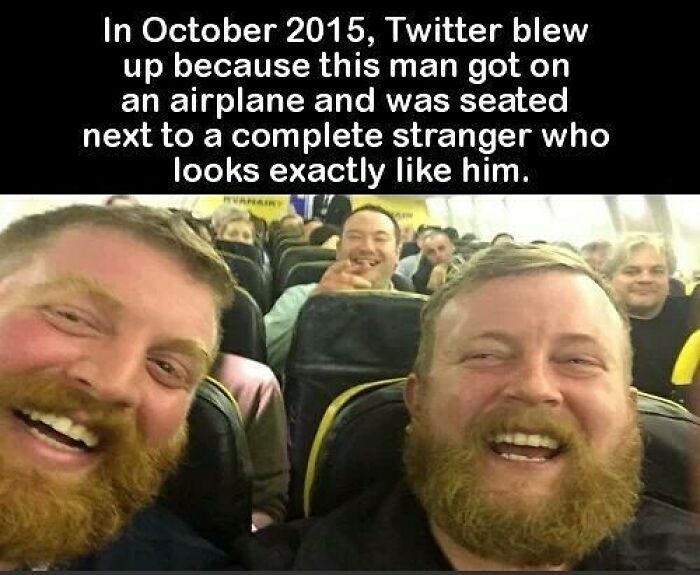 Two men with beards smiling on an airplane, highlighting a creepy fact about identical strangers seated together.