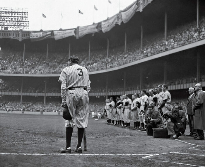 Black and white photo of a baseball player standing at the field, capturing an iconic moment in sports history.
