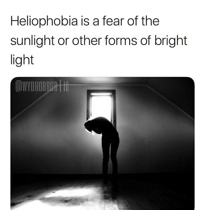 Silhouetted person bent over in dark room with bright window light illustrating heliophobia in creepy facts and pics.