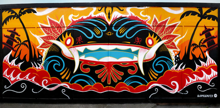 Colorful street art mural featuring abstract shapes, waves, and palm trees, showcasing vibrant street art creativity on an urban canvas.