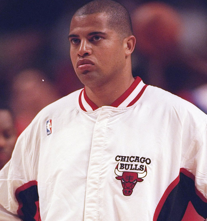 Professional basketball player in a Chicago Bulls warm-up jacket featured in unsolved celebrity disappearances topic.