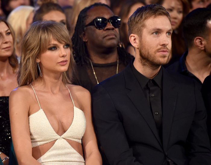 Taylor Swift and Travis Kelce sitting side by side at a formal event, body language expert observing their interaction.