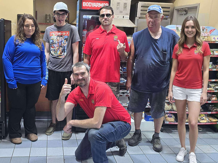 Group of people posing together inside a viral impossible to visit truck stop believed to be the real location Group of people posing together inside a viral impossible to visit truck stop believed to be the real location