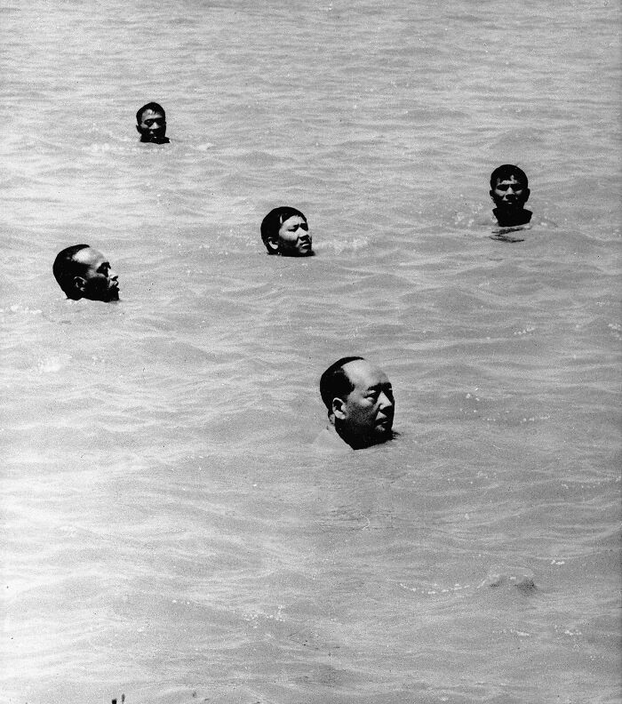 Five men partially submerged in water, representing a powerful and iconic 20th century image with symbolic significance.