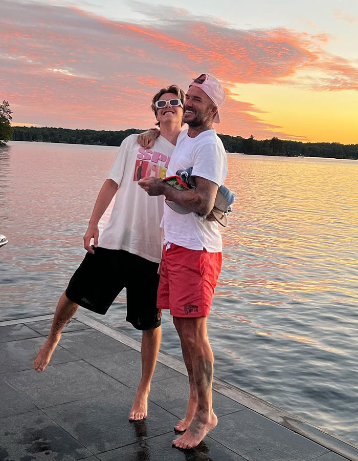 Cruz Beckham and David Beckham laughing on dock at sunset, highlighting Cruz Beckham's bulge in casual summer attire. Cruz Beckham and David Beckham laughing on dock at sunset, highlighting Cruz Beckham's bulge in casual summer attire.