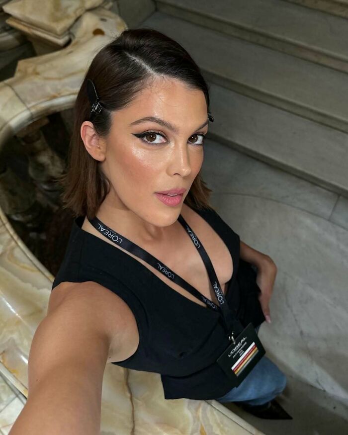 Close-up selfie of a woman with makeup and polished look, representing Miss Universe winners in stunning photos.