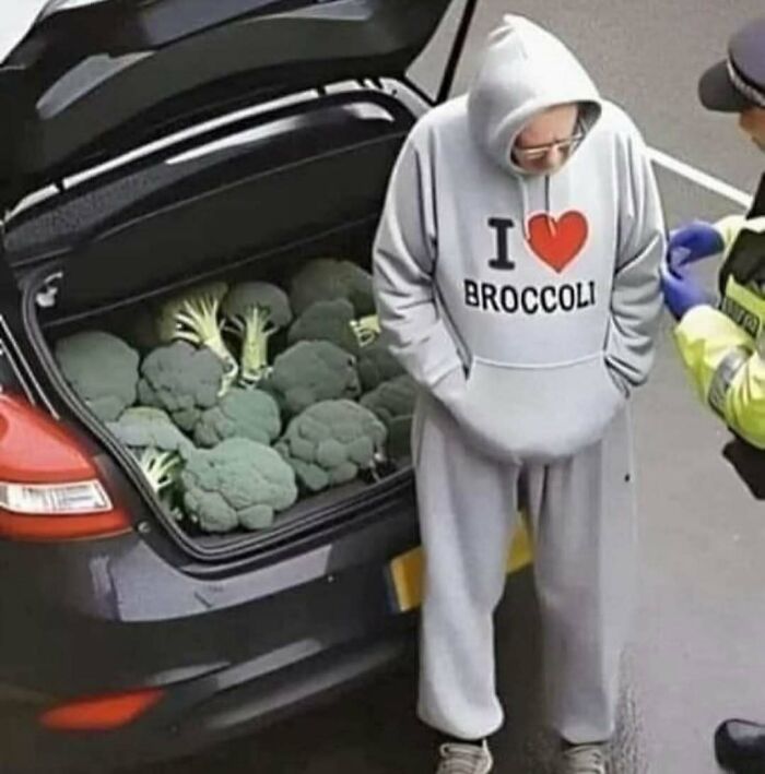 Man wearing I love broccoli hoodie next to car trunk full of broccoli in a bizarre cursed image from a popular IG page