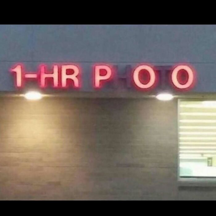 Partial neon sign showing a humorous cursed image with missing letters spelling an unintended word.