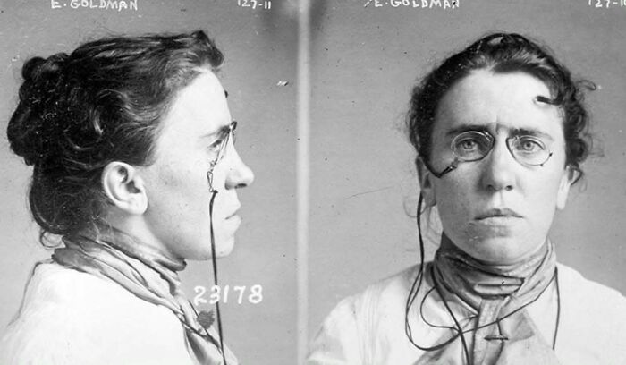 Black and white mugshot of a woman with glasses and a serious expression, symbolizing common folk making a mark in history.
