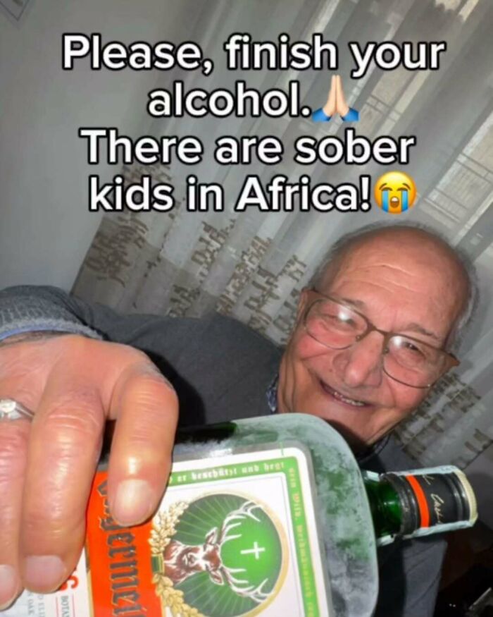 Elderly man smiling and holding a bottle of alcohol with a dark humor meme about sober kids in Africa.