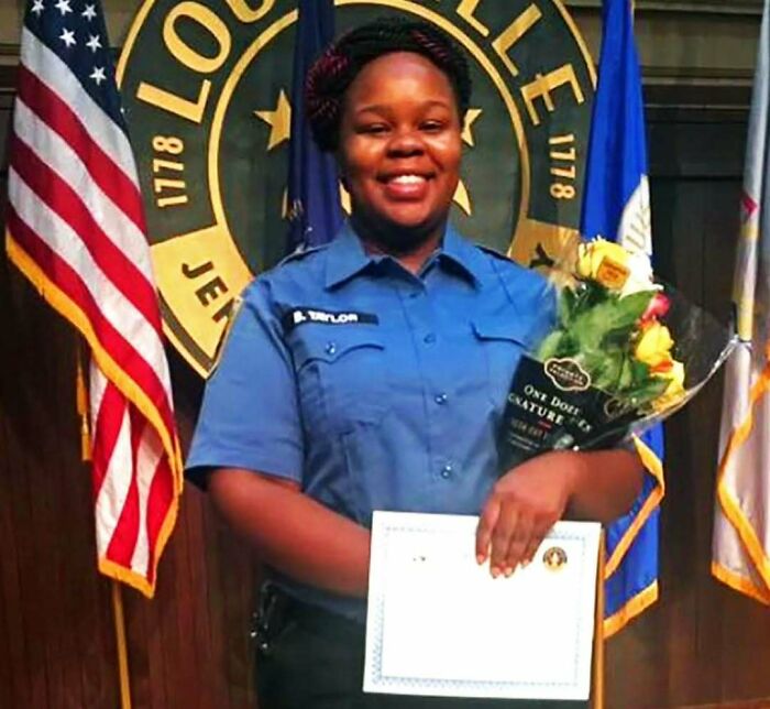 Smiling common folk member in uniform holding flowers and certificate, making a huge mark in society and history.