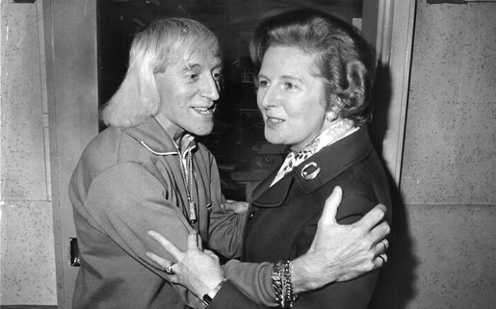 Two people warmly embracing, illustrating common folk making a huge mark in society and history.