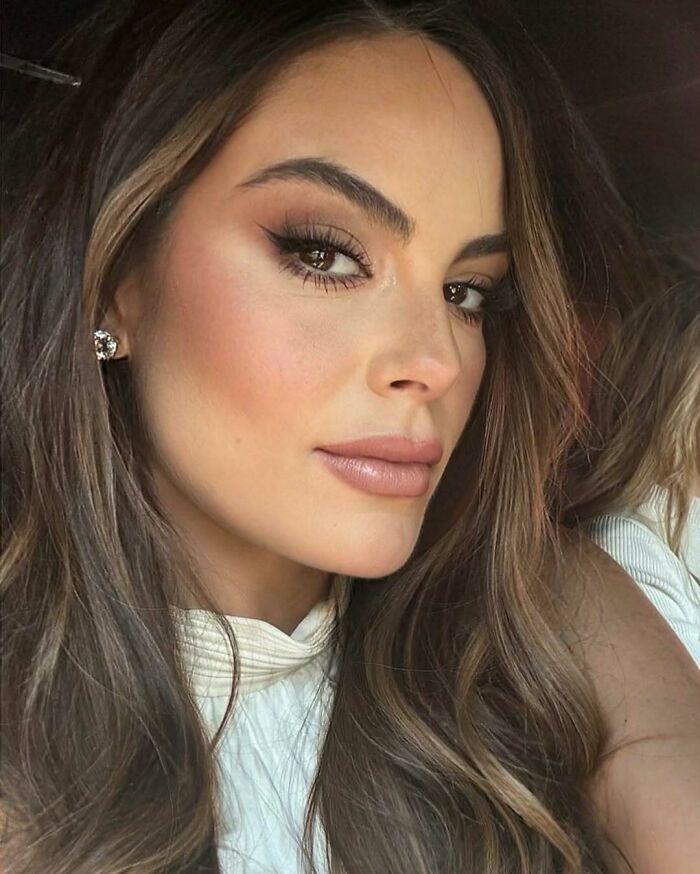 Close-up of a Miss Universe winner with flawless makeup and long hair, showcasing beauty in a stunning photo portrait.