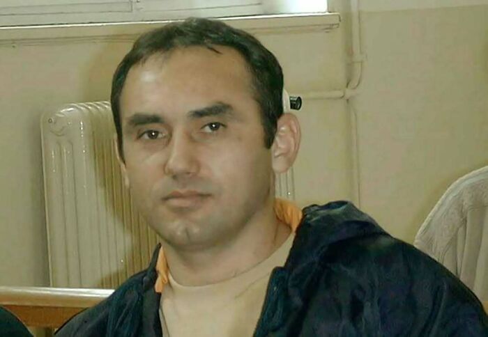 Man with dark hair wearing a black jacket and beige shirt, representing common folk who made a huge mark in history.